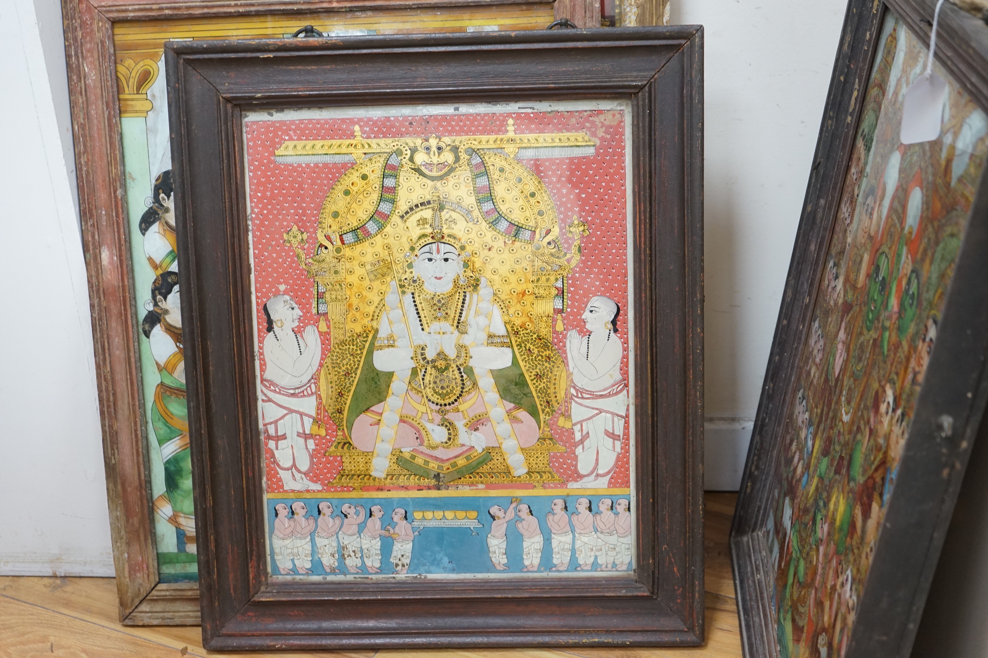 A collection of eight Indian reverse decorated glass pictures, 20th century, largest frame 70cm X 60cm